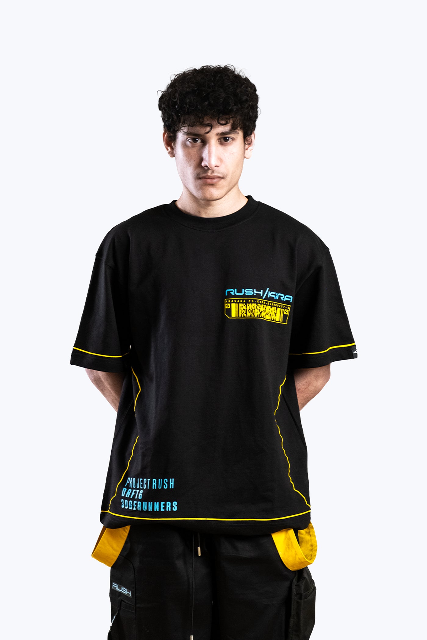 Person wearing a black t-shirt with yellow accents and text on a white background