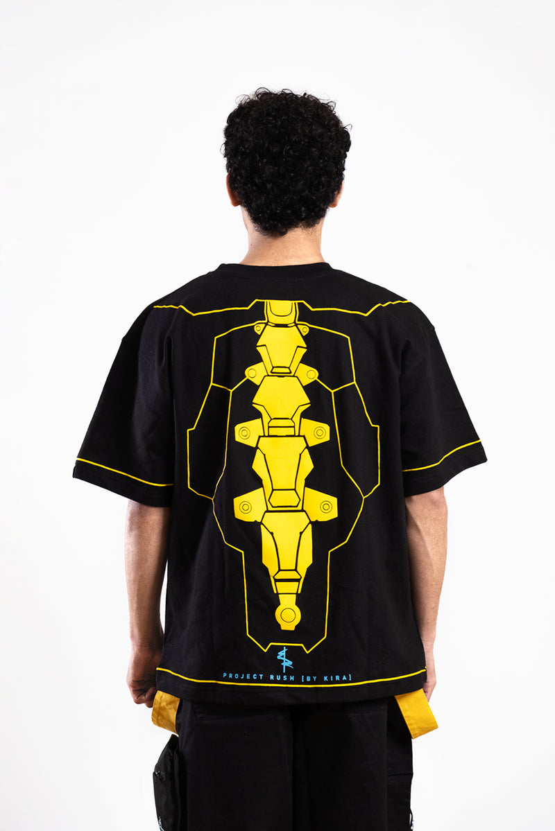Person wearing a black t-shirt with yellow graphic design on the back against a white background